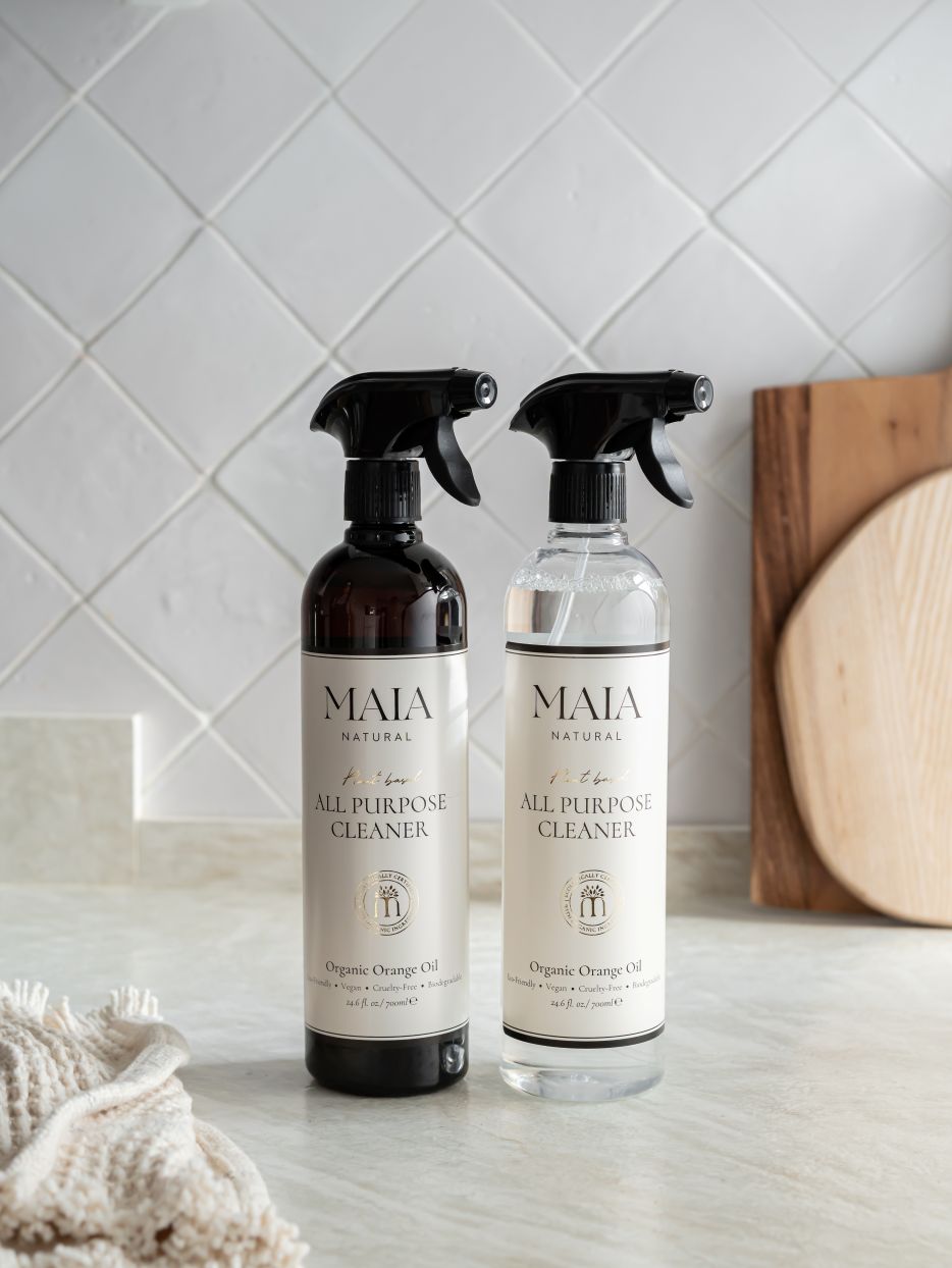 Two spray bottles with black pumps, one larger than the other, labeled &